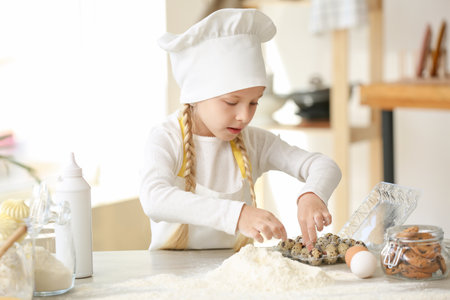 Cute little chef cooking in kitchen