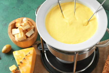 Cheese fondue on tableの写真素材