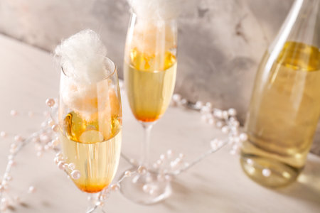 Glasses with tasty cotton candy cocktail on tableの写真素材
