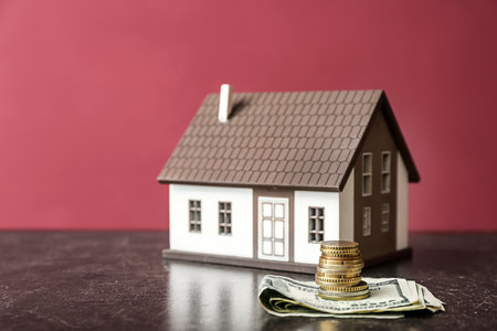 Figure of house and money on table. Concept of buying real estateの写真素材