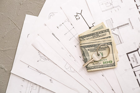 Drawings of house, key and money on table. Concept of buying real estateの写真素材