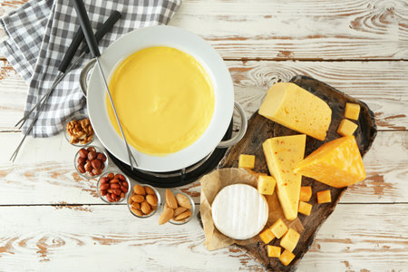 Cheese fondue with snacks on table