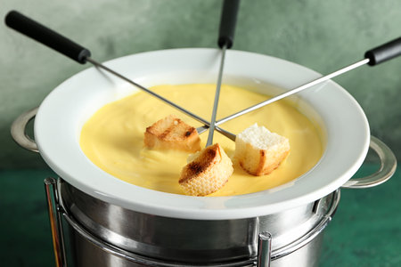 Cheese fondue with croutons on tableの写真素材
