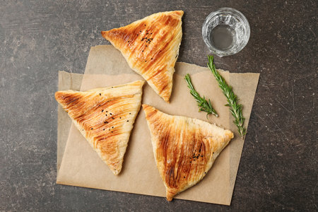 Delicious samosas on gray background