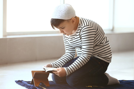 Little Muslim boy praying indoorsの写真素材