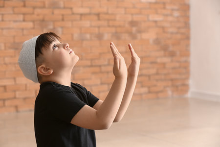 Little Muslim boy praying indoorsの写真素材