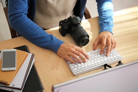 Male photographer working on computer in studio