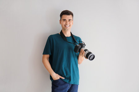 Male photographer on light background