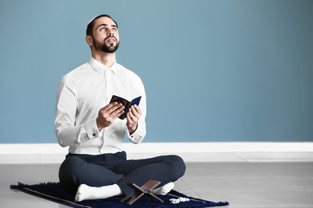 Young Muslim man praying indoorsの写真素材