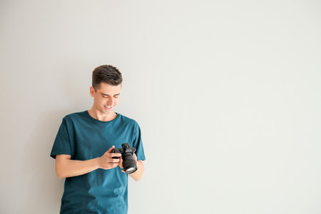 Male photographer on light backgroundの写真素材