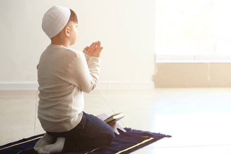 Little Muslim boy praying indoorsの写真素材