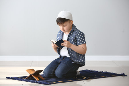 Little Muslim boy praying indoorsの写真素材