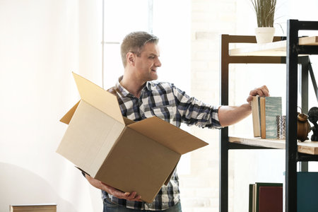 Handsome mature man after moving into new house