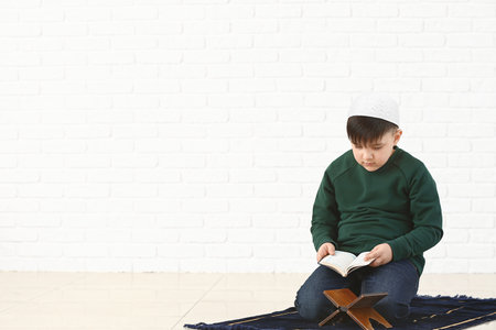 Little Muslim boy praying indoorsの写真素材
