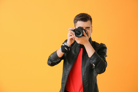 Male photographer on color backgroundの写真素材