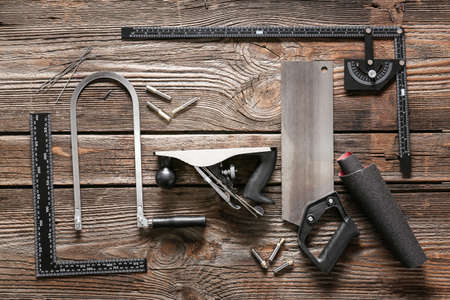 Set of carpenter's tools on wooden background