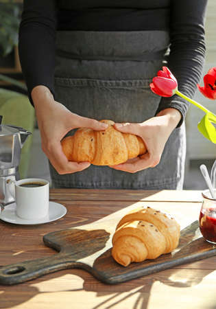 Woman preparing breakfast with growing and coffee at table