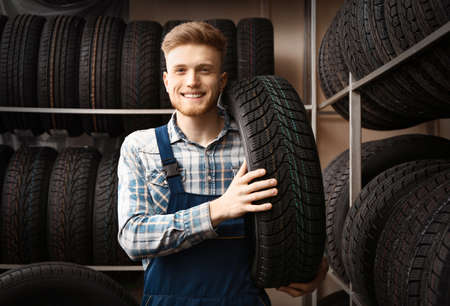 Male seller in car tire store
