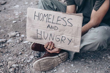 Poor homeless man begging for help outdoorsの写真素材