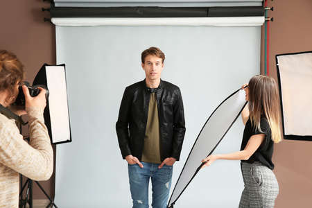 Professional photographer working with model in studio