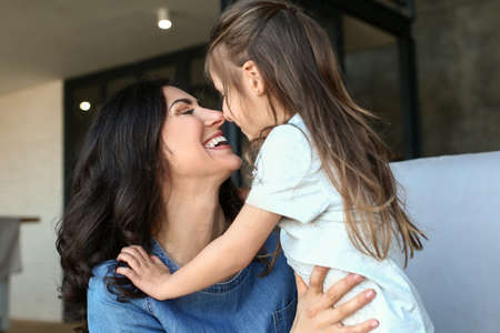 Portrait of happy mother and daughter at home