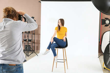 Professional photographer working with model in studioの写真素材