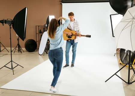 Professional photographer working with model in studioの写真素材