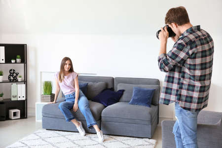 Professional photographer working with model in studio