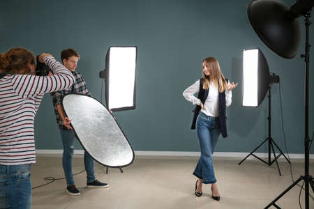 Professional photographer working with model in studioの写真素材