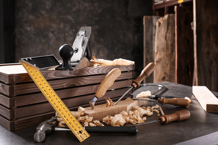 Tools of carpenter on table in workshopの写真素材