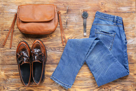 Set of clothes and accessories on wooden background