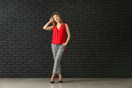 Portrait of mature woman against dark wallの写真素材