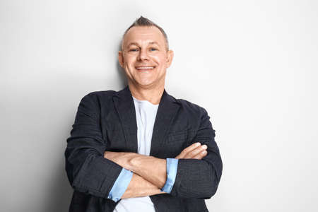 Portrait of handsome middle-aged man on light background