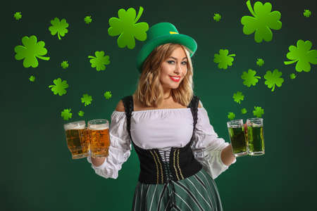 Beautiful young woman with beer on color background. St. Patrick's day celebration