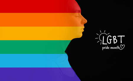 Rainbow silhouette of young woman on dark background with text LGBT PRIDE MONTHの写真素材