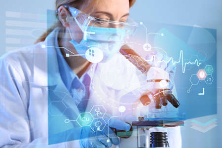 Scientist working with microscope in laboratory