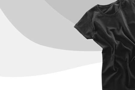 Blank black t-shirt on gray background with space for text