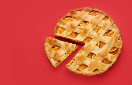 Tasty orange pie on color backgroundの写真素材