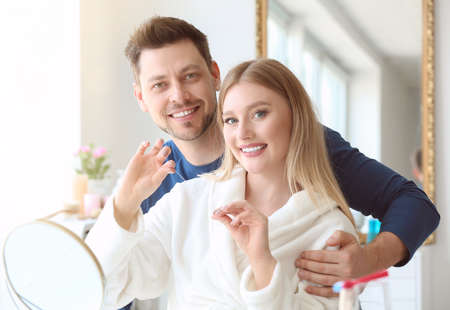 Couple flossing teeth at homeの写真素材