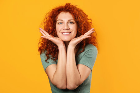 Happy redhead woman on color background