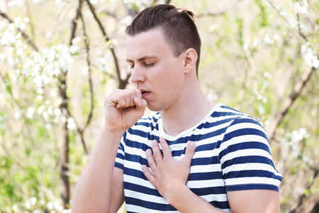 Man with allergy on spring day