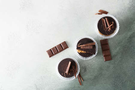 Tasty chocolate peanut butter cups on color backgroundの写真素材