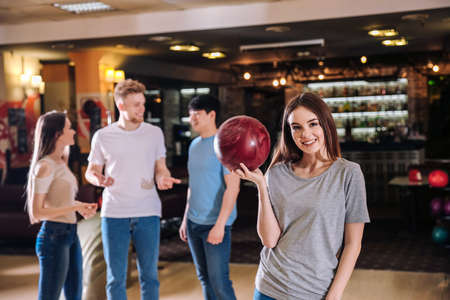 Young woman with her friends in bowling clubの写真素材