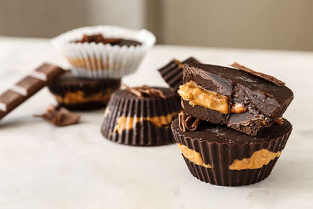 Tasty chocolate peanut butter cups on tableの写真素材