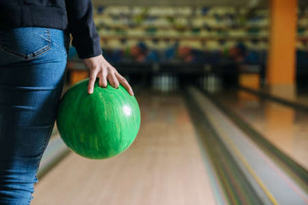 Young woman playing bowling in clubの写真素材