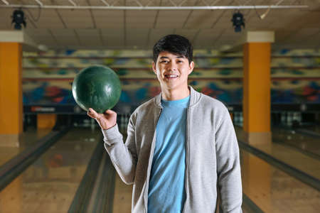 Young Asian man in bowling clubの写真素材