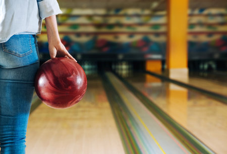 Young woman playing bowling in clubの写真素材