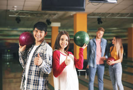 Happy friends in bowling clubの写真素材