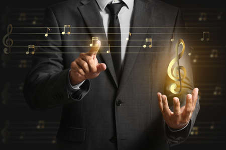 Male composer on dark background, closeup