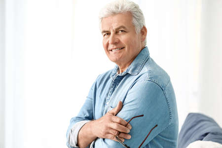 Portrait of handsome senior man at home
